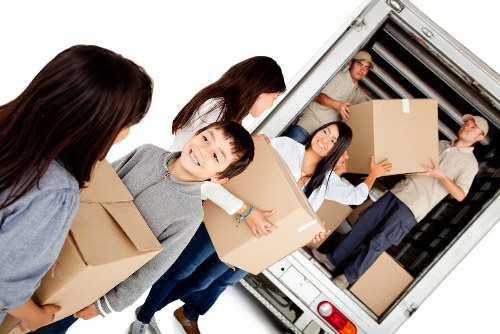 Furniture pick-up team collecting a sofa from a Harrow home