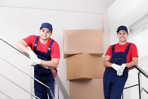 Movers handling desks, files, and IT equipment during a business relocation