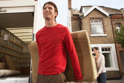 Professional moving van team handling boxes and furniture in Harrow